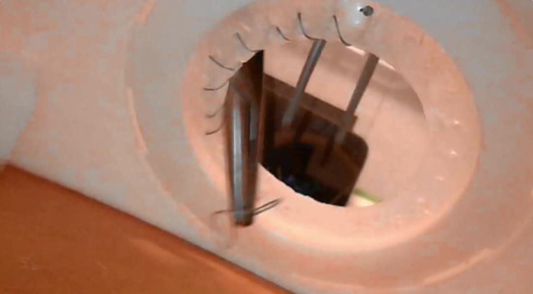 Close-up of the needle driver entering the practice tissue
